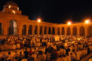 Mosque at night with people, lit up
