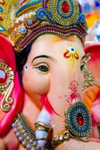 Pink elephant statue close-up with bangles and jewels and paint