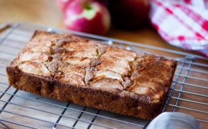 Apple cake on sheet with apple in background