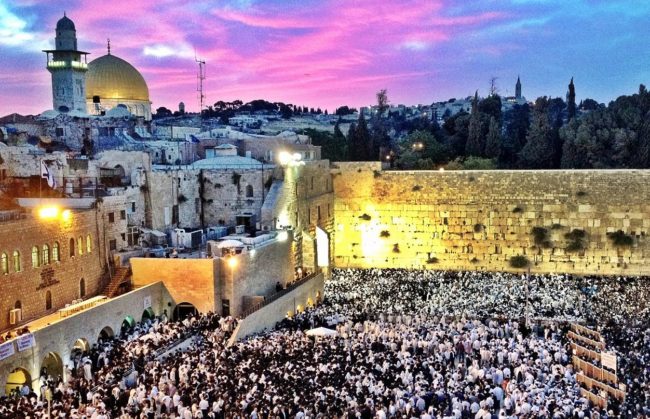 Crowds gather at the Western Wall at sunrise