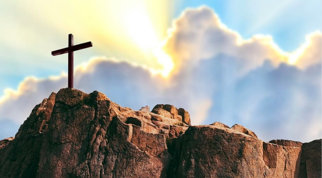 Crucifix on cliff, sunshine, Easter