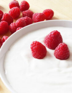 Bowl of yogurt with raspberries