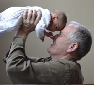 older man with baby, father's day